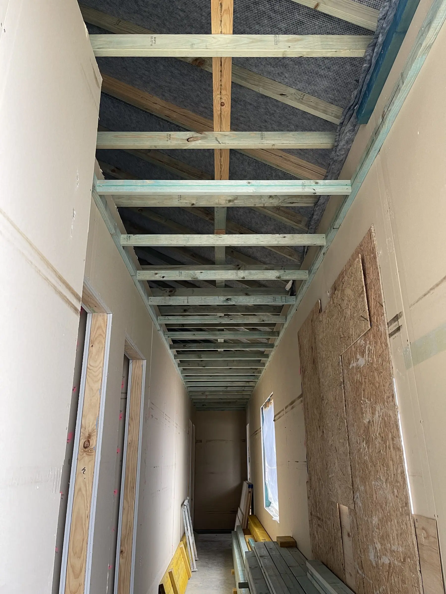 Compact wet area under construction with framing and services roughed in