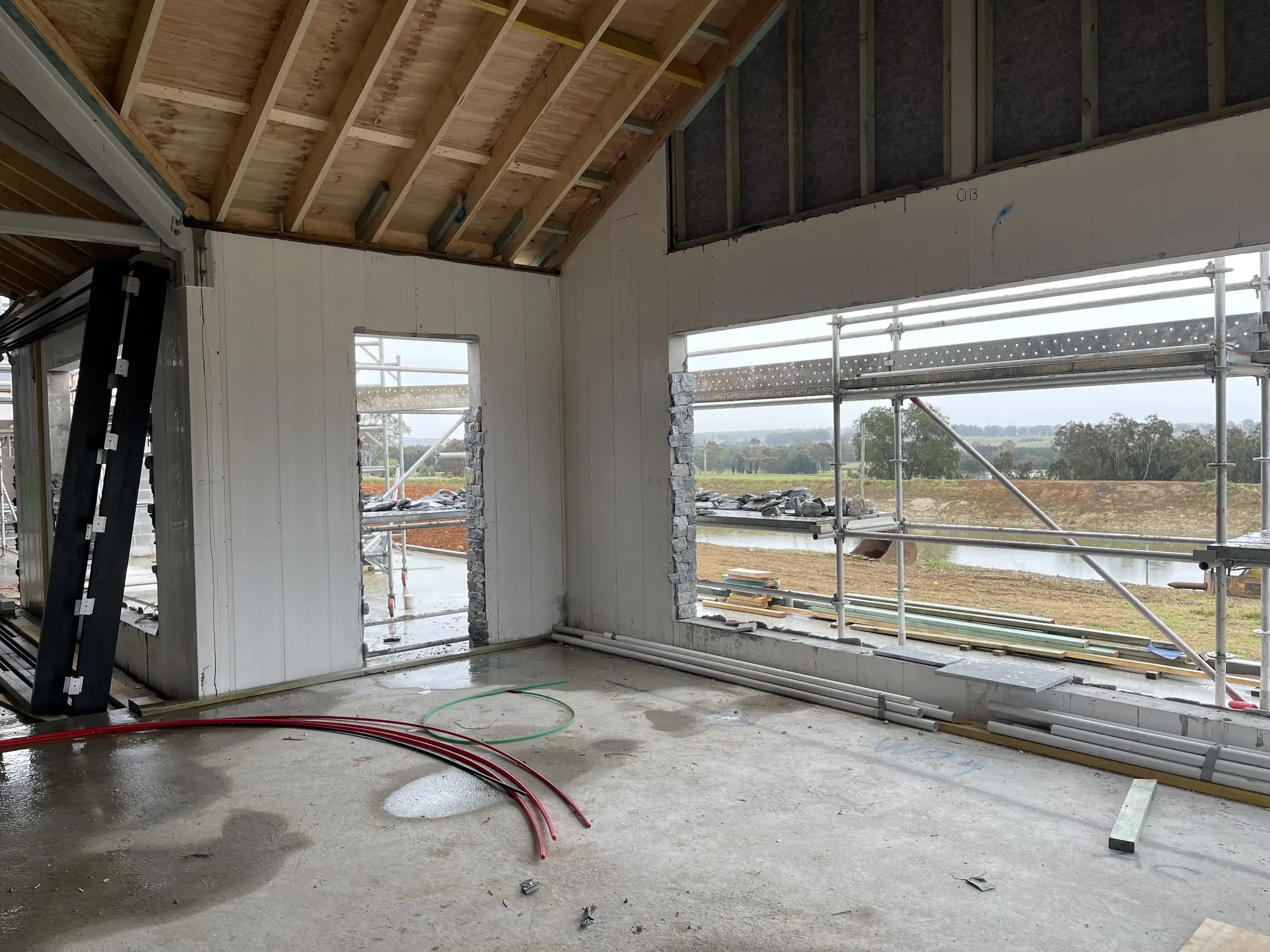 Interior fit-out with new linings and large windows over Hunter farmland