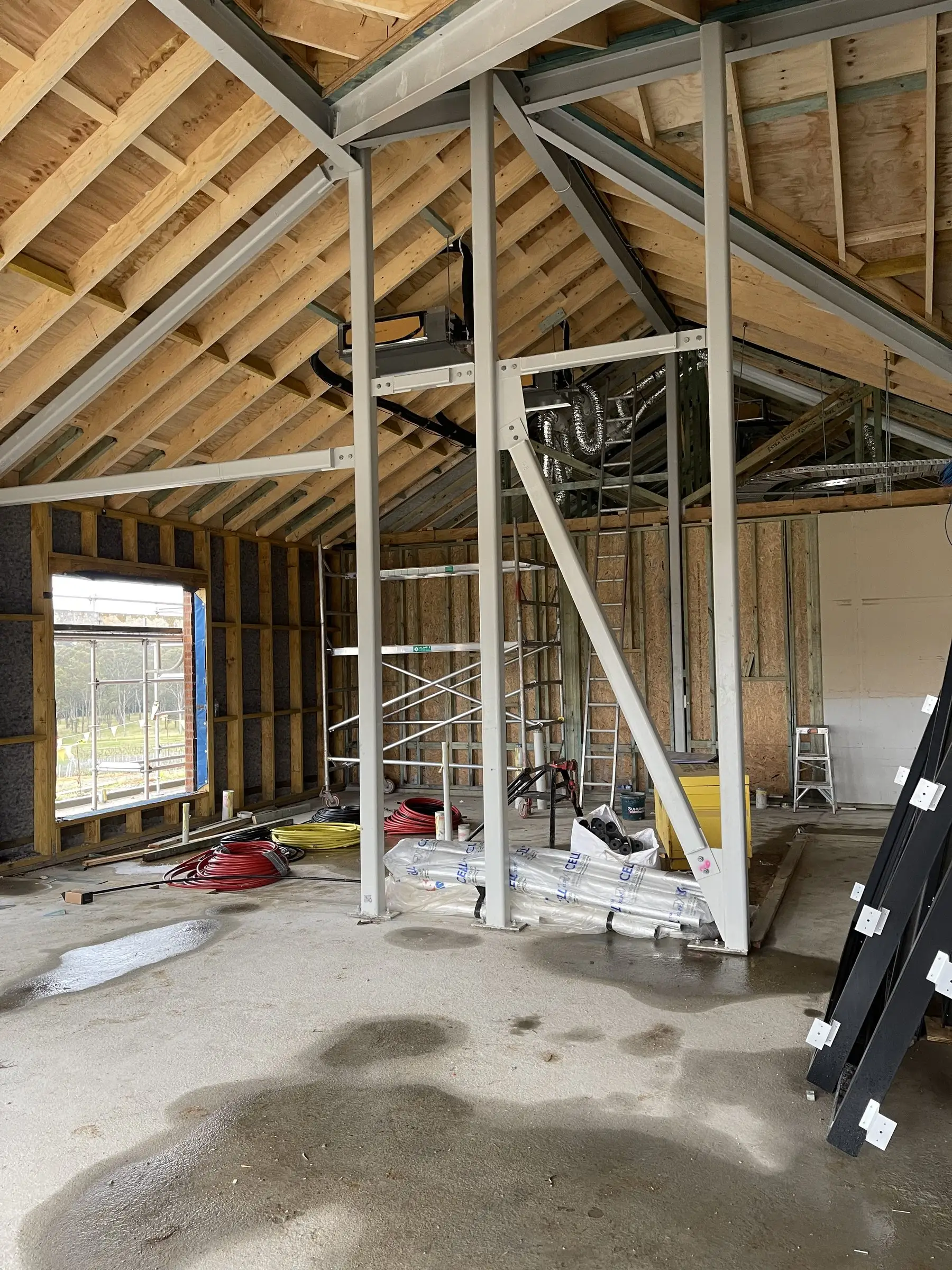 Cathedral roof framing with a structural steel portal frame