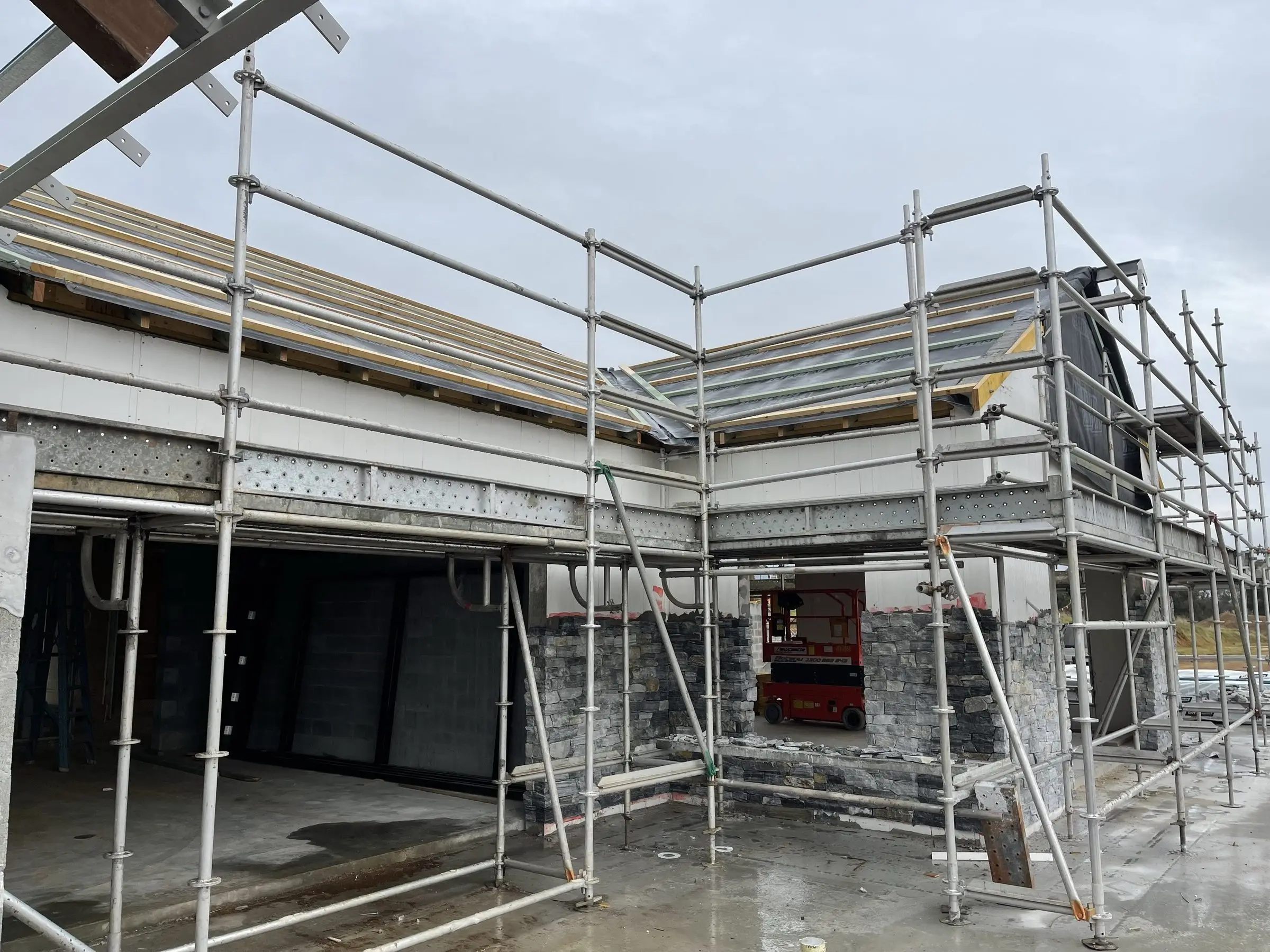 Two-storey home extension under construction with scaffolding